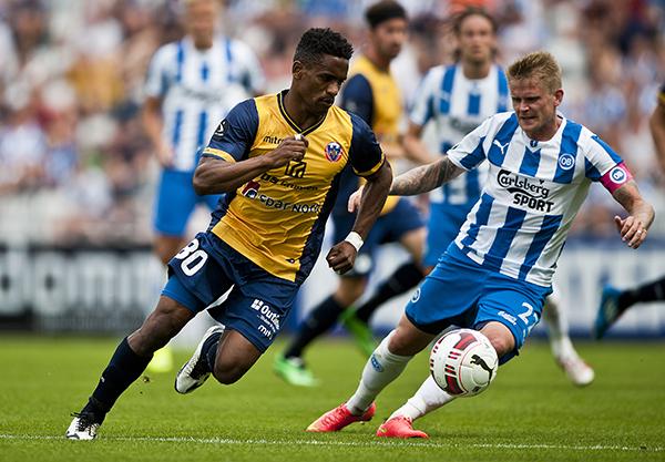 ODENSE, DENMARK - JULY 20: Quincy Antipas of Hobro IK and Ari Skulason of OB Odense compete for the ball during the Danish Superliga match between OB Odense and Hobro IK at TREFOR Park on July 20, 2014 in Odense, Denmark. (Photo by Lars Ronbog / FrontZoneSport via Getty Images)